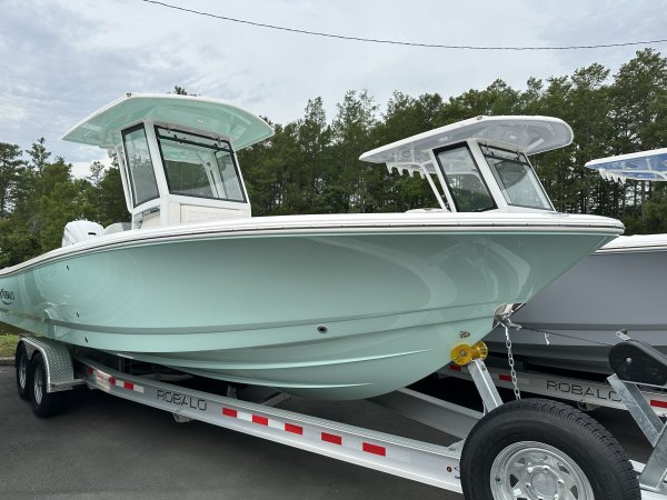The definition of an outboard motor is a detachable engine mounted on outboard brackets on the stern of your boat.  This configuration will have only one single engine.